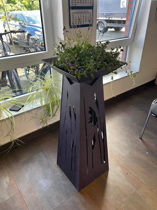 Lila gefärbte Blumensäule mit Gräsern als Motiv