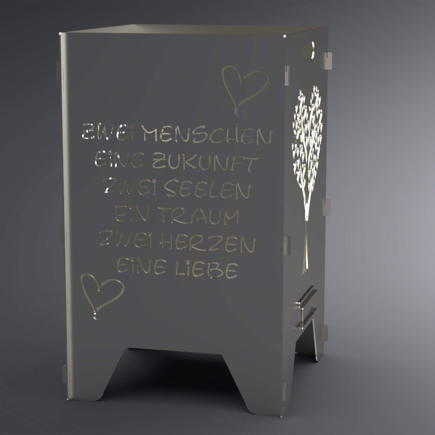 Feuertonne mit Spruch: "Zwei Menschen, eine Zukunft, zwei Seelen, ein Traum, zwei Herzen, eine Liebe" auf zwei Seiten. Zwei Seiten haben einen Herzförmigen Baum als Motiv. Spruch steht im Vordergrund.