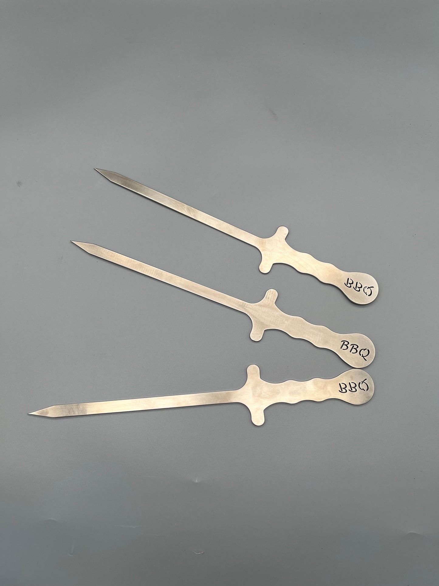 drei Grillspieße in kurz mit dem Schriftzug BBQ am Griff