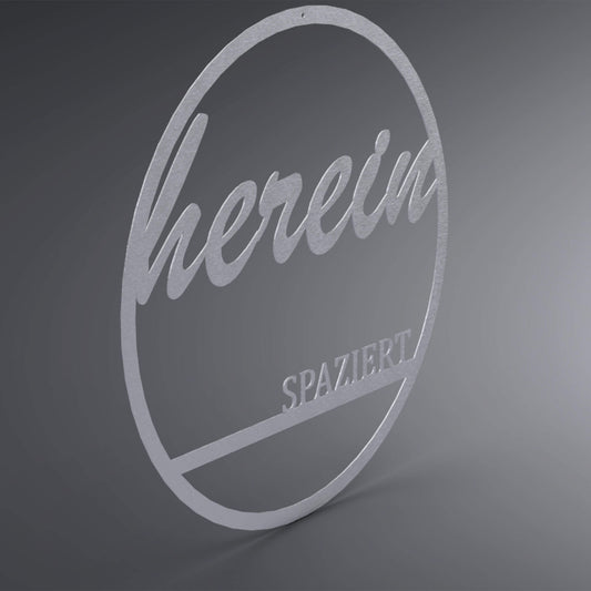 Dünner, ausgehöhlter Kreis. Oben steht verschnörkelt: "herein" und unten steht auf einer Linie in Druckbuchstaben: "spaziert". Seitliche Ansicht.