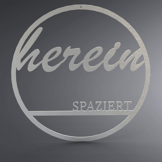 Dünner, ausgehöhlter Kreis. Oben steht verschnörkelt: "herein" und unten steht auf einer Linie in Druckbuchstaben: "spaziert".
